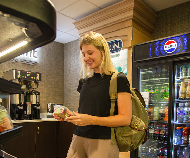 Girl holding salad in airport 